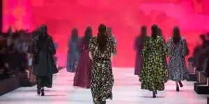 Emerging designer showcasing eco-luxury collection on runway